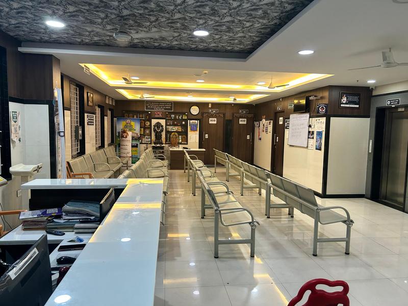Reception desk and OPD waiting area outside the consultation rooms at Mahalakshmi Multispeciality Hospital, Shivamogga